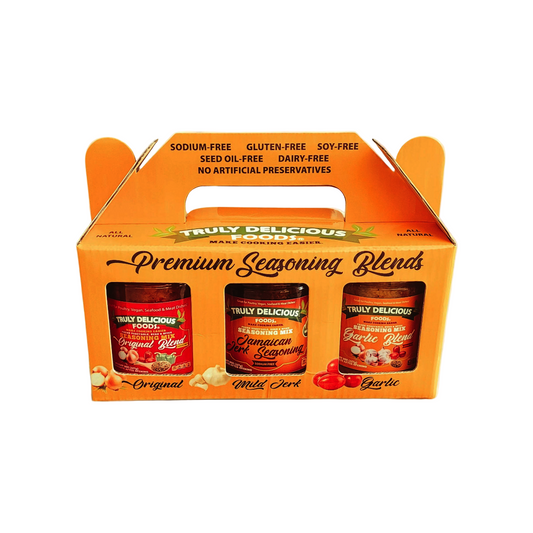 Mustard packaging of Truly Delicious Foods STARTER KIT 8oz Original Blend | 8oz Mild Jamaican Jerk | 8oz Garlic Blend)seasoning blends on a marble background